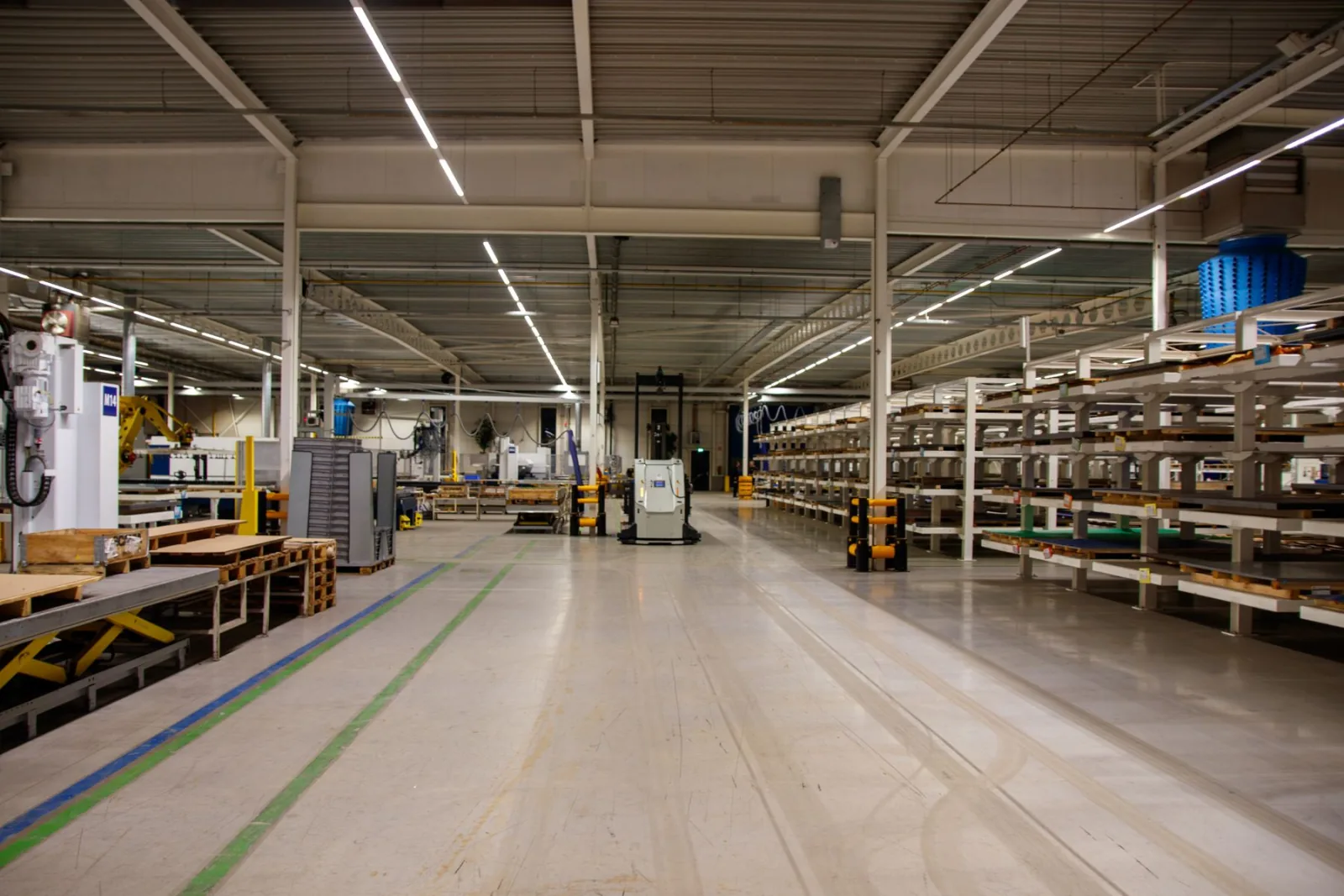 A bright warehouse interior lined with stocked racking.