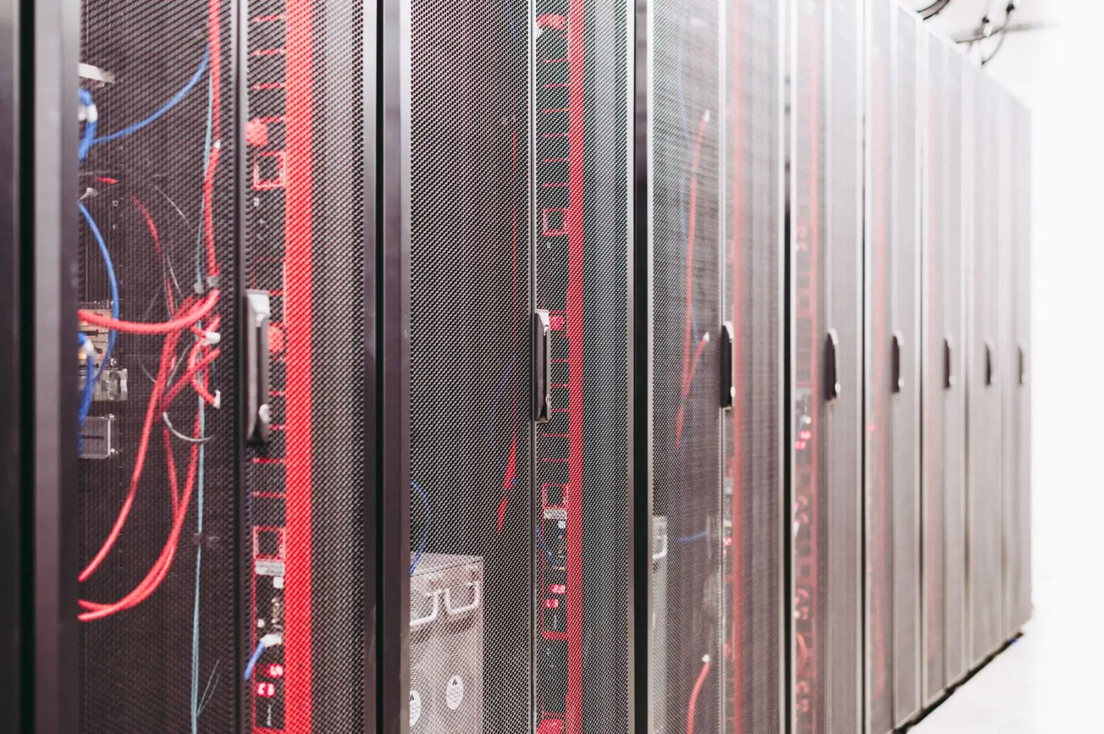 An aisle of server racks in a modern data center.
