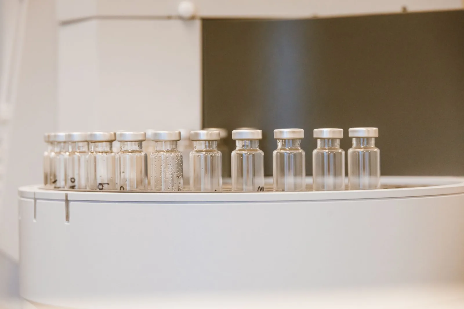 A row of empty glass vials in a rack.